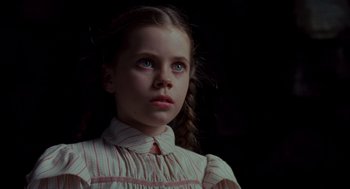 Movie still from “Return to Oz” (1985), directed by Walter Murch – A young girl in a striped dress looking at the camera; Close Up shot, Low angle