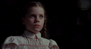 Movie still from “Return to Oz” (1985), directed by Walter Murch – A young girl in a striped dress looking up at the sky; Close Up shot, Low angle