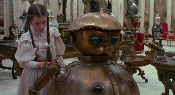 Movie still from “Return to Oz” (1985), directed by Walter Murch – A girl standing next to a large metal robot; Close Up shot, High angle