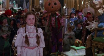 Movie still from “Return to Oz” (1985), directed by Walter Murch – A group of people dressed up in costumes; Medium shot, High angle