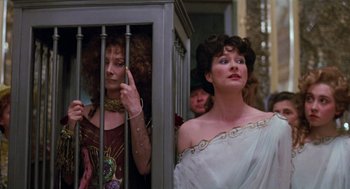 Movie still from “Return to Oz” (1985), directed by Walter Murch – Two women are standing behind bars in front of a mirror; Medium shot, Low angle
