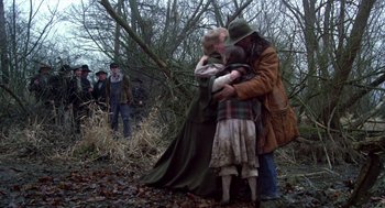 Movie still from “Return to Oz” (1985), directed by Walter Murch – A group of people hugging in the woods; Wide shot, Over the shoulder angle