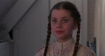 Movie still from “Return to Oz” (1985), directed by Walter Murch – A young girl with long braids wearing a dress; Close Up shot, High angle
