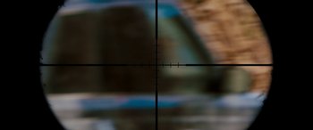 Movie still from “Revenge” (2017), directed by Coralie Fargeat – A rifle scope with a blurry background; Extreme Close Up shot, Low angle
