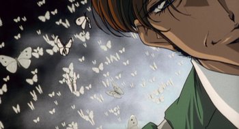 Movie still from “Revolutionary Girl Utena: The Movie” (1999), directed by Katsushi Sakurabi – A person's face with butterflies flying in the background; Extreme Close Up shot, Low angle