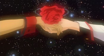 Movie still from “Revolutionary Girl Utena: The Movie” (1999), directed by Katsushi Sakurabi – A hand holding a red rose in front of a space background; Extreme Close Up shot, Overhead angle