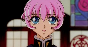 Movie still from “Revolutionary Girl Utena: The Movie” (1999), directed by Katsushi Sakurabi – A person's face with pink hair and blue eyes; Close Up shot, Low angle