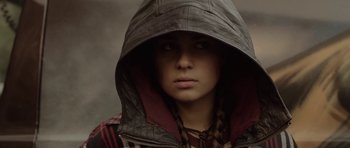 Movie still from “Rhymes for Young Ghouls” (2013), directed by Jeff Barnaby – A person with a hood is looking at the camera; Close Up shot, Over the shoulder angle