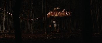 Movie still from “Rhymes for Young Ghouls” (2013), directed by Jeff Barnaby – A tree house in the middle of the woods at night; Extreme Wide shot, Low angle