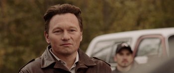 Movie still from “Rhymes for Young Ghouls” (2013), directed by Jeff Barnaby – A person wearing a brown jacket; Close Up shot, Over the shoulder angle