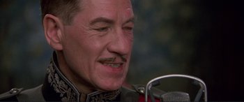 Movie still from “Richard III” (1995), directed by Richard Loncraine – A person with a mustache; Close Up shot, Over the shoulder angle
