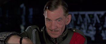 Movie still from “Richard III” (1995), directed by Richard Loncraine – An older man in a military uniform looking at the camera; Close Up shot, Low angle
