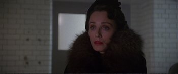 Movie still from “Richard III” (1995), directed by Richard Loncraine – A person wearing a hat and a fur coat; Close Up shot, Over the shoulder angle