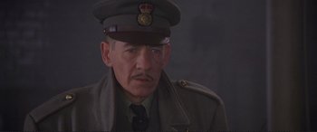 Movie still from “Richard III” (1995), directed by Richard Loncraine – An older man wearing a uniform and a hat; Close Up shot, Low angle