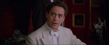 Movie still from “Richard III” (1995), directed by Richard Loncraine – A person wearing a suit and tie; Close Up shot, High angle