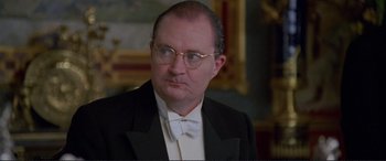 Movie still from “Richard III” (1995), directed by Richard Loncraine – An older man in a suit and glasses; Close Up shot, High angle
