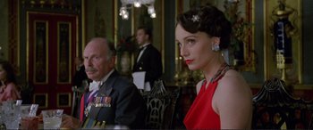 Movie still from “Richard III” (1995), directed by Richard Loncraine – A man and a woman sitting at a dinner table; Medium shot, Low angle