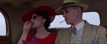 Movie still from “Richard III” (1995), directed by Richard Loncraine – An older man and a young woman sitting in the back of a car; Close Up shot, Low angle