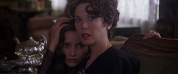 Movie still from “Richard III” (1995), directed by Richard Loncraine – A woman with her hand on her head and another woman with her hand on her head; Close Up shot, Over the shoulder angle