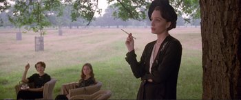 Movie still from “Richard III” (1995), directed by Richard Loncraine – A woman holding a pen in her hand while standing next to a girl; Medium shot, Low angle