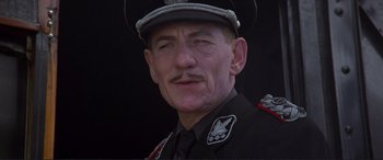 Movie still from “Richard III” (1995), directed by Richard Loncraine – An older man wearing a uniform and a hat; Close Up shot, Low angle