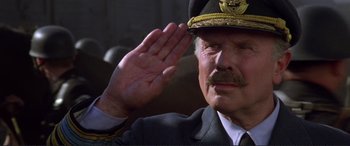 Movie still from “Richard III” (1995), directed by Richard Loncraine – An older man saluting in a military uniform; Close Up shot, Low angle