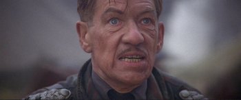 Movie still from “Richard III” (1995), directed by Richard Loncraine – An older man with a mustache and a beard; Close Up shot, Low angle