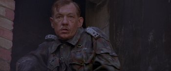 Movie still from “Richard III” (1995), directed by Richard Loncraine – A person wearing a military uniform; Close Up shot, Low angle