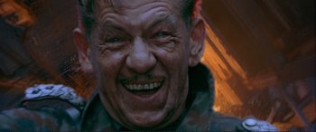 Movie still from “Richard III” (1995), directed by Richard Loncraine – An older man smiling with his mouth wide open; Close Up shot, Low angle