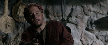 Movie still from “Risen” (2016), directed by Kevin Reynolds – A man with a beard is holding a cell phone in his hand; Close Up shot, Over the shoulder angle