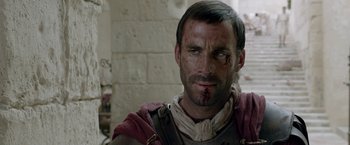 Movie still from “Risen” (2016), directed by Kevin Reynolds – A person with a bandage on his face; Close Up shot, Over the shoulder angle