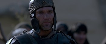 Movie still from “Risen” (2016), directed by Kevin Reynolds – A person wearing a helmet; Close Up shot, Over the shoulder angle
