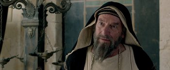 Movie still from “Risen” (2016), directed by Kevin Reynolds – An old man with a beard and a beard covering his head; Close Up shot, Over the shoulder angle