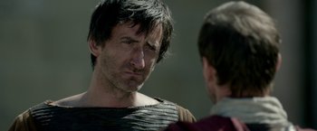 Movie still from “Risen” (2016), directed by Kevin Reynolds – A man in roman garb talking to another man; Close Up shot, Over the shoulder angle