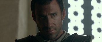 Movie still from “Risen” (2016), directed by Kevin Reynolds – A man's face in a dark room; Close Up shot, Low angle
