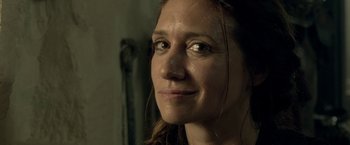 Movie still from “Risen” (2016), directed by Kevin Reynolds – A woman's face in a dark room; Close Up shot, Over the shoulder angle