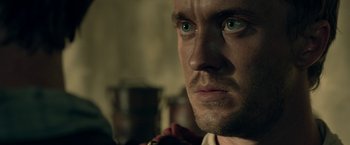 Movie still from “Risen” (2016), directed by Kevin Reynolds – A man's face in a dark room; Close Up shot, Over the shoulder angle