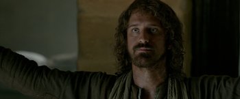 Movie still from “Risen” (2016), directed by Kevin Reynolds – A person with long hair and a beard; Close Up shot, Over the shoulder angle
