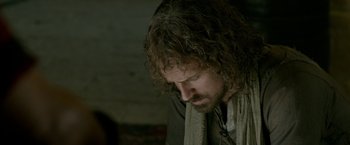 Movie still from “Risen” (2016), directed by Kevin Reynolds – A person with long curly hair; Close Up shot, Over the shoulder angle