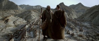 Movie still from “Risen” (2016), directed by Kevin Reynolds – Two men are standing on a rocky hillside; Wide shot, Low angle