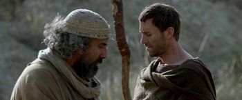 Movie still from “Risen” (2016), directed by Kevin Reynolds – Two men are talking in the wilderness together; Close Up shot, Over the shoulder angle