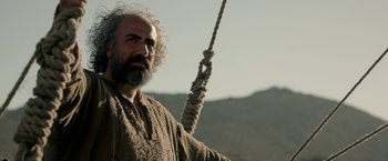 Movie still from “Risen” (2016), directed by Kevin Reynolds – A man with a beard holding onto a rope; Close Up shot, Low angle