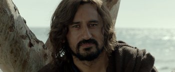 Movie still from “Risen” (2016), directed by Kevin Reynolds – A person with long hair and a beard; Close Up shot, Over the shoulder angle