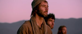 Movie still from “Risen” (2016), directed by Kevin Reynolds – A man with a beard wearing a hat and a scarf; Close Up shot, Low angle