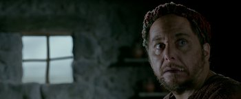 Movie still from “Risen” (2016), directed by Kevin Reynolds – A person wearing a hat; Close Up shot, Over the shoulder angle