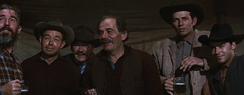 Movie still from “River of No Return” (1954), directed by Otto Preminger – A group of men standing next to each other; Medium shot, Low angle