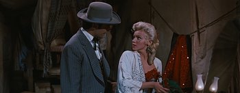 Movie still from “River of No Return” (1954), directed by Otto Preminger – A man and a woman standing next to each other; Medium shot, Over the shoulder angle