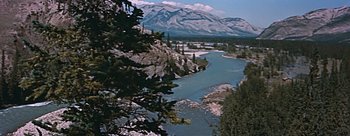 Movie still from “River of No Return” (1954), directed by Otto Preminger – A view of a river with a mountain in the background; Extreme Wide shot, High angle