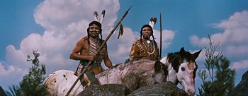 Movie still from “River of No Return” (1954), directed by Otto Preminger – A couple of native americans standing on top of rocks; Medium shot, Low angle