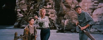 Movie still from “River of No Return” (1954), directed by Otto Preminger – A woman and a boy are walking in the snow; Wide shot, Low angle